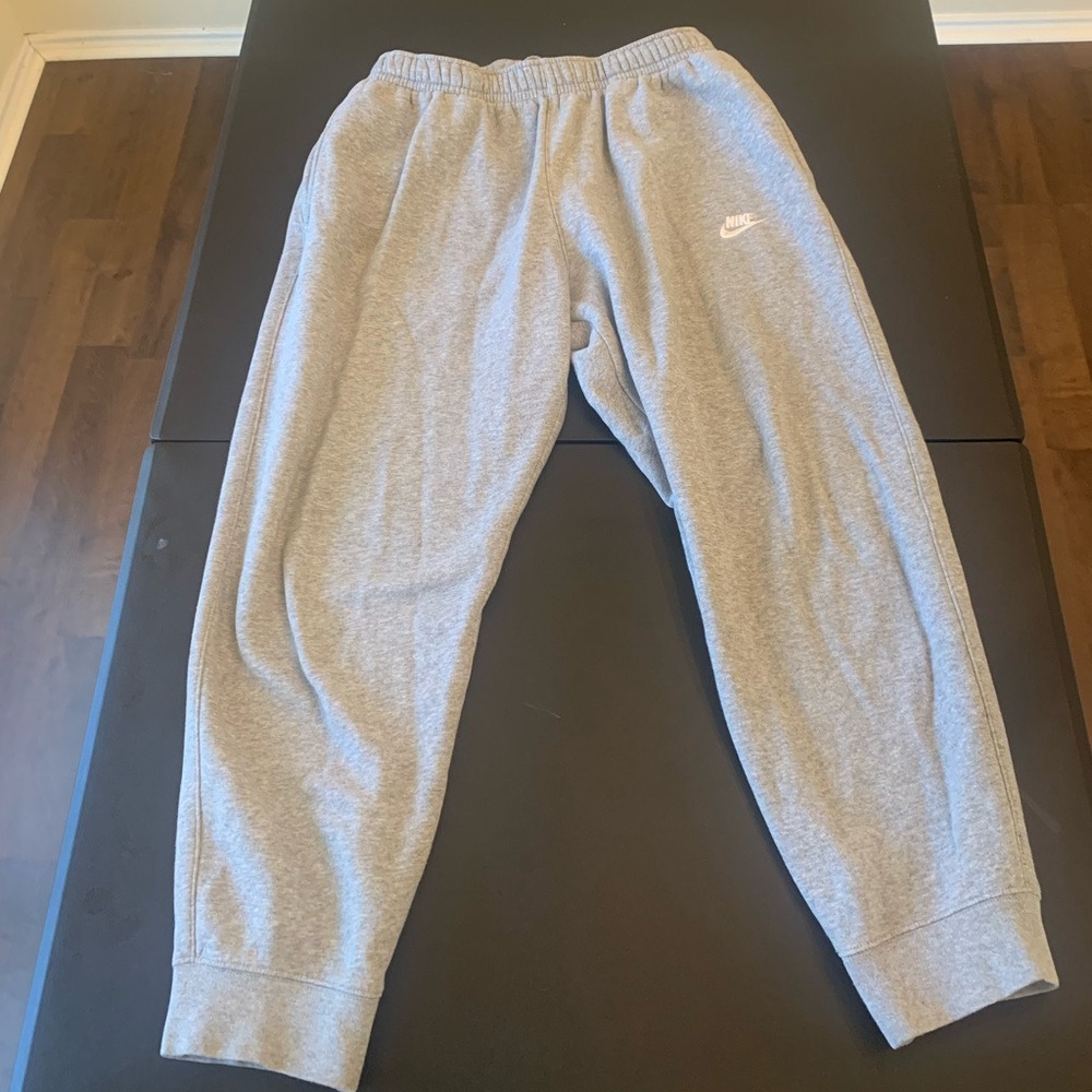 Gray Nike sweatpants with two pockets in front and one pocket on the back.